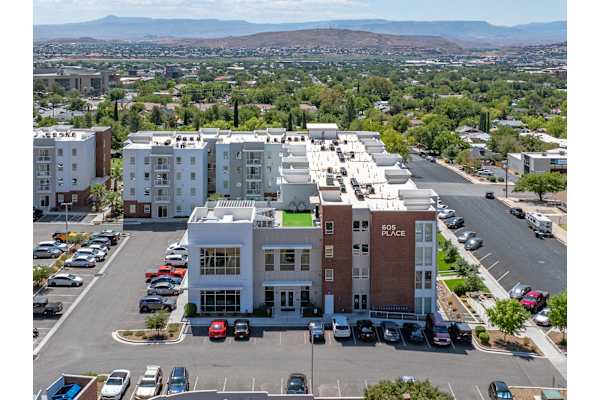 A parking lot with cars and a building that says 805 Place. at 605 Place Student Housing & Co-Living, Utah